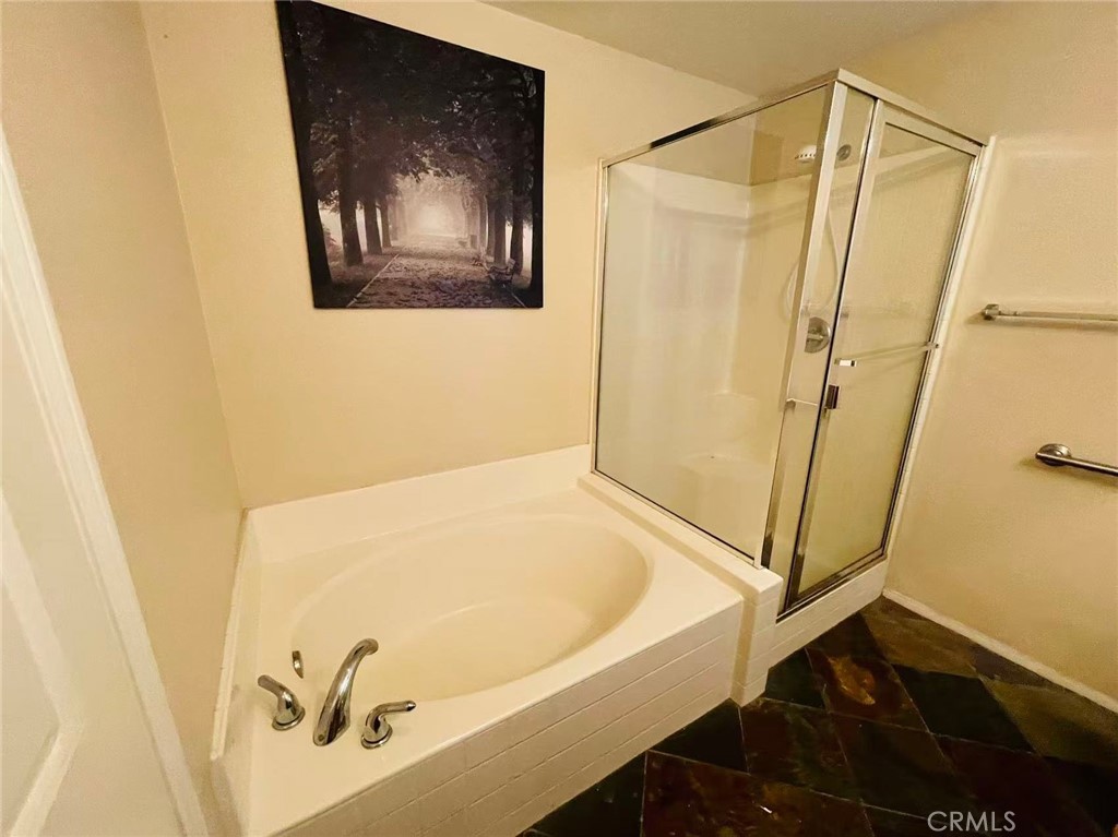 7353 Ellena West, Unit 28 Rancho Cucamonga, CA 91730 - Photo 20 of 29 a bathroom with a tub and shower