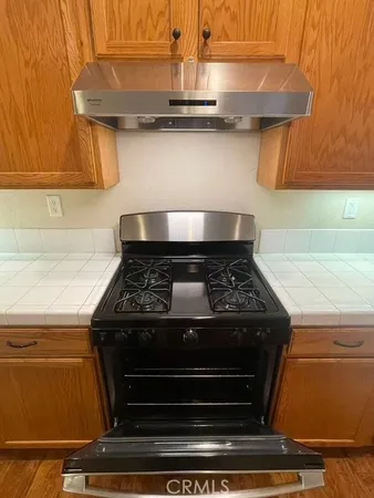 a stove top oven sitting inside of a kitchen