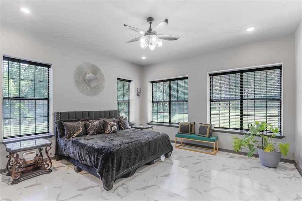 1373 George Ephram Cord 166 Road Overton, TX 75684 - Photo 28 of 40 Spacious room featuring light-toned walls, recessed lighting, a ceiling fan with integrated lighting, multiple windows with dark frames, and large format tile flooring