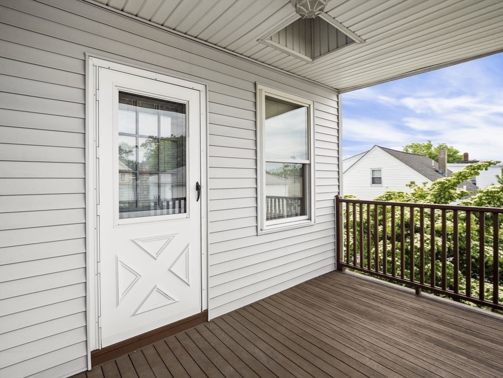 69 Stowers Street, Unit 2 Revere, MA 02151 - Photo 13 of 17 a view of a balcony with wooden floor and fence
