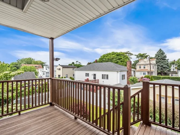 a view of backyard with deck and garden