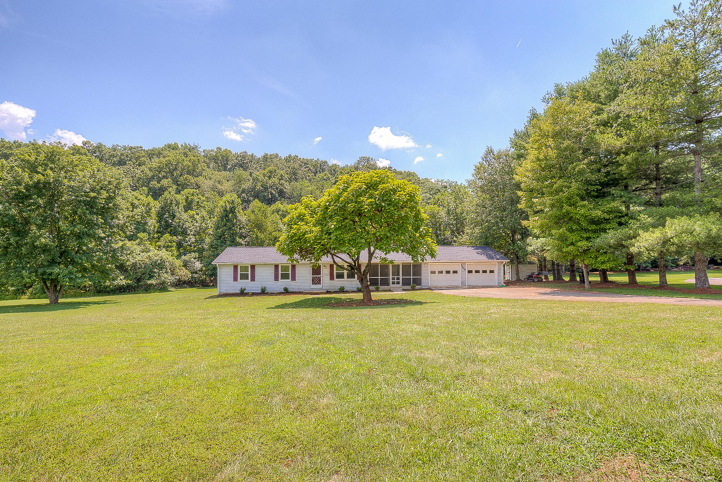 2509 Rutrough Road Southeast Roanoke, VA 24014 - Photo 1 of 28 a view of a large pool with lawn chairs and large trees