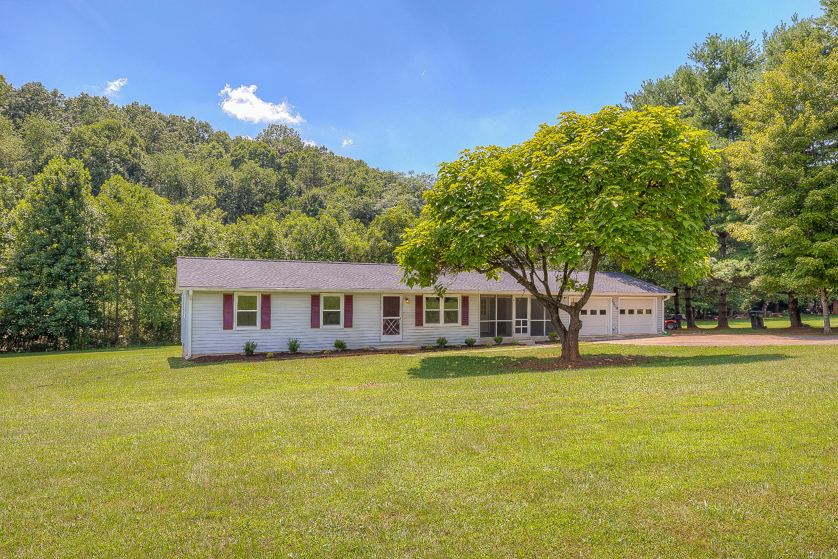 2509 Rutrough Road Southeast Roanoke, VA 24014 - Photo 2 of 28 a view of a house with a big yard and large trees