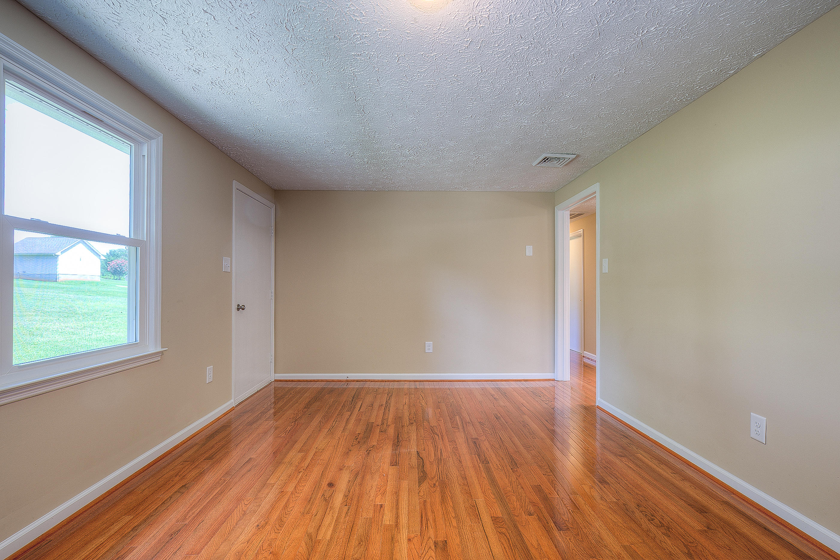 2509 Rutrough Road Southeast Roanoke, VA 24014 - Photo 17 of 28 an empty room with wooden floor and windows