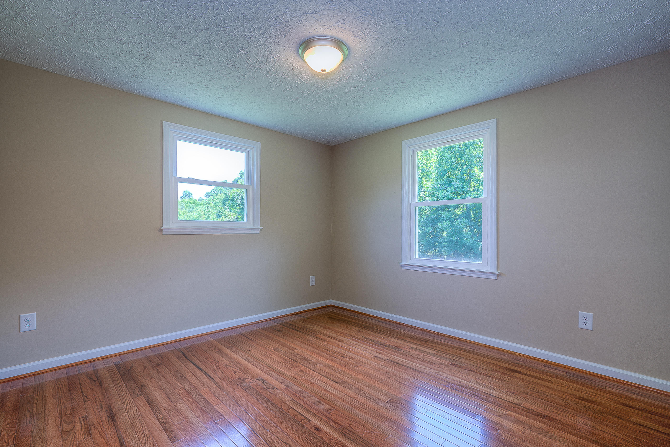 2509 Rutrough Road Southeast Roanoke, VA 24014 - Photo 19 of 28 an empty room with wooden floor and windows