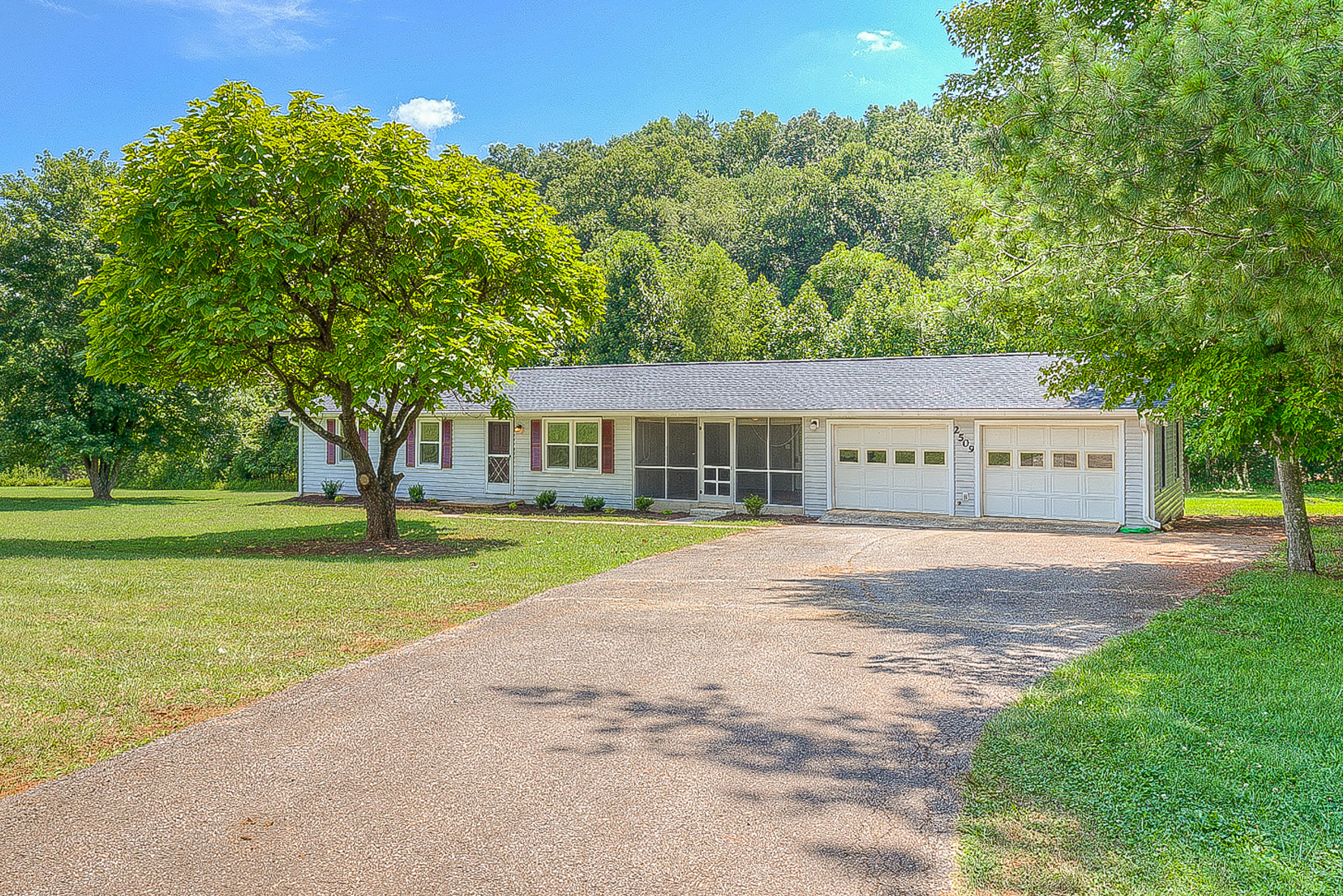 2509 Rutrough Road Southeast Roanoke, VA 24014 - Photo 3 of 28 a front view of a house with a yard and trees