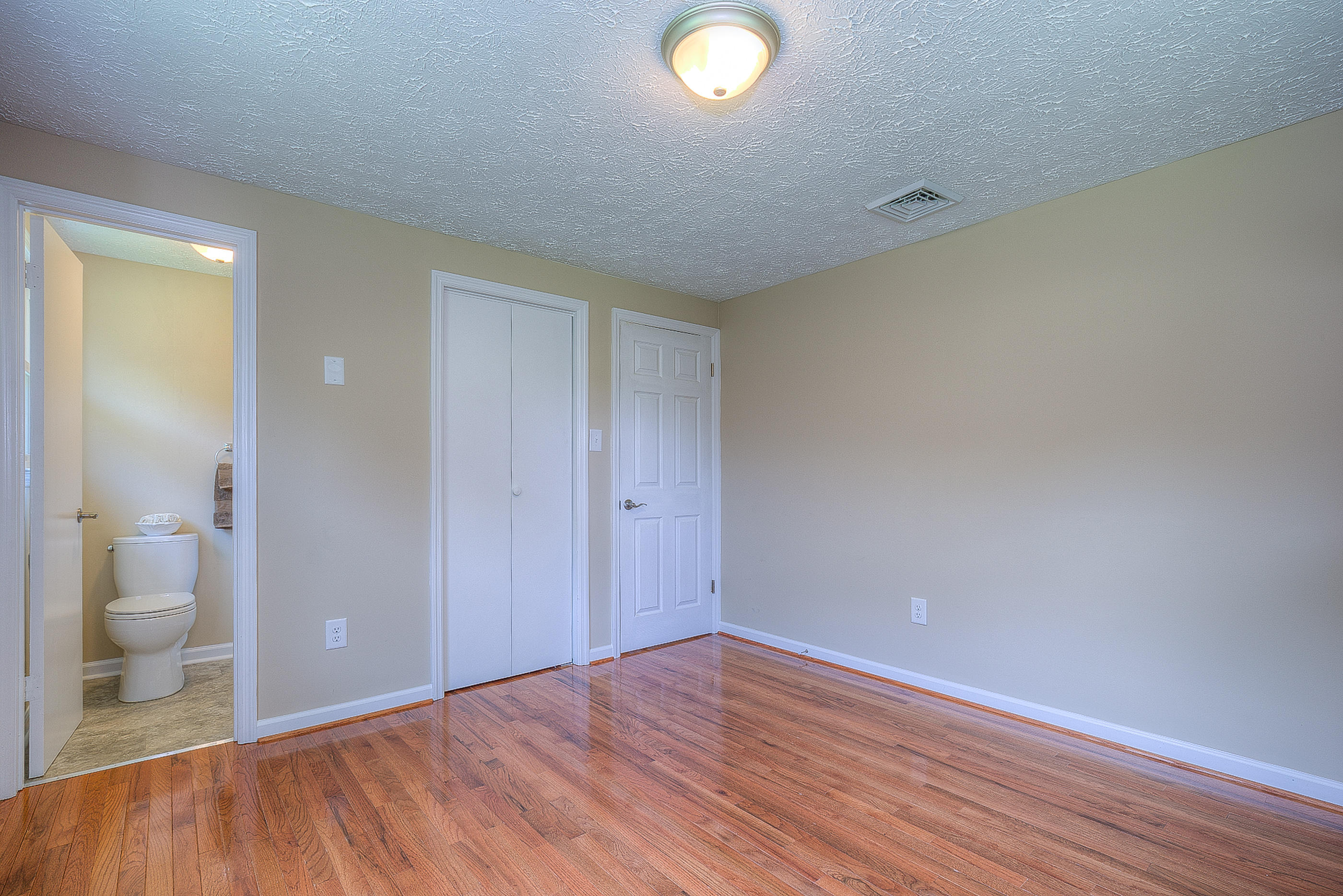 2509 Rutrough Road Southeast Roanoke, VA 24014 - Photo 21 of 28 wooden floor in an empty room and a bathroom