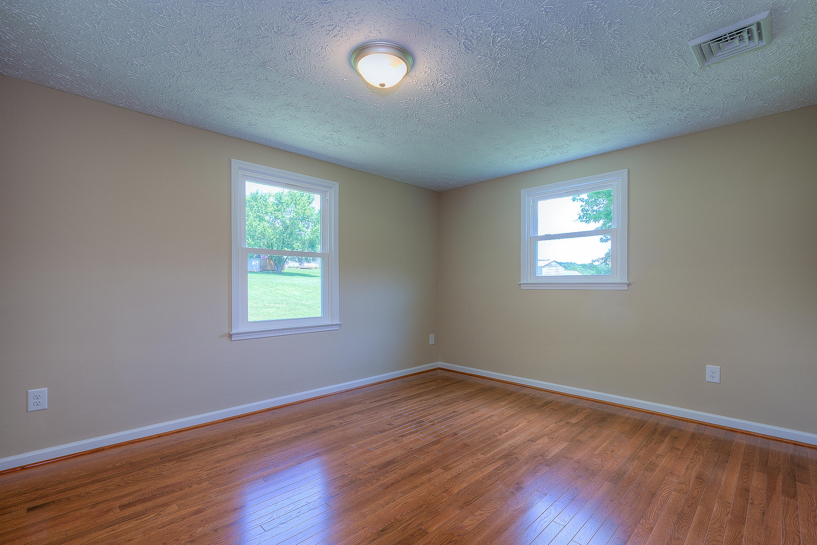 2509 Rutrough Road Southeast Roanoke, VA 24014 - Photo 23 of 28 a view of a room that has wooden floor and window in it