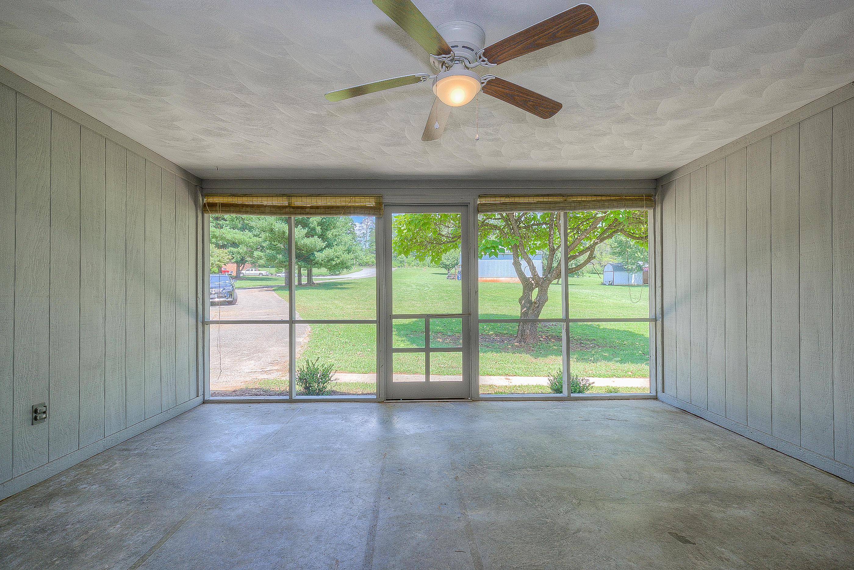 2509 Rutrough Road Southeast Roanoke, VA 24014 - Photo 6 of 28 an empty room with large windows and ceiling fan
