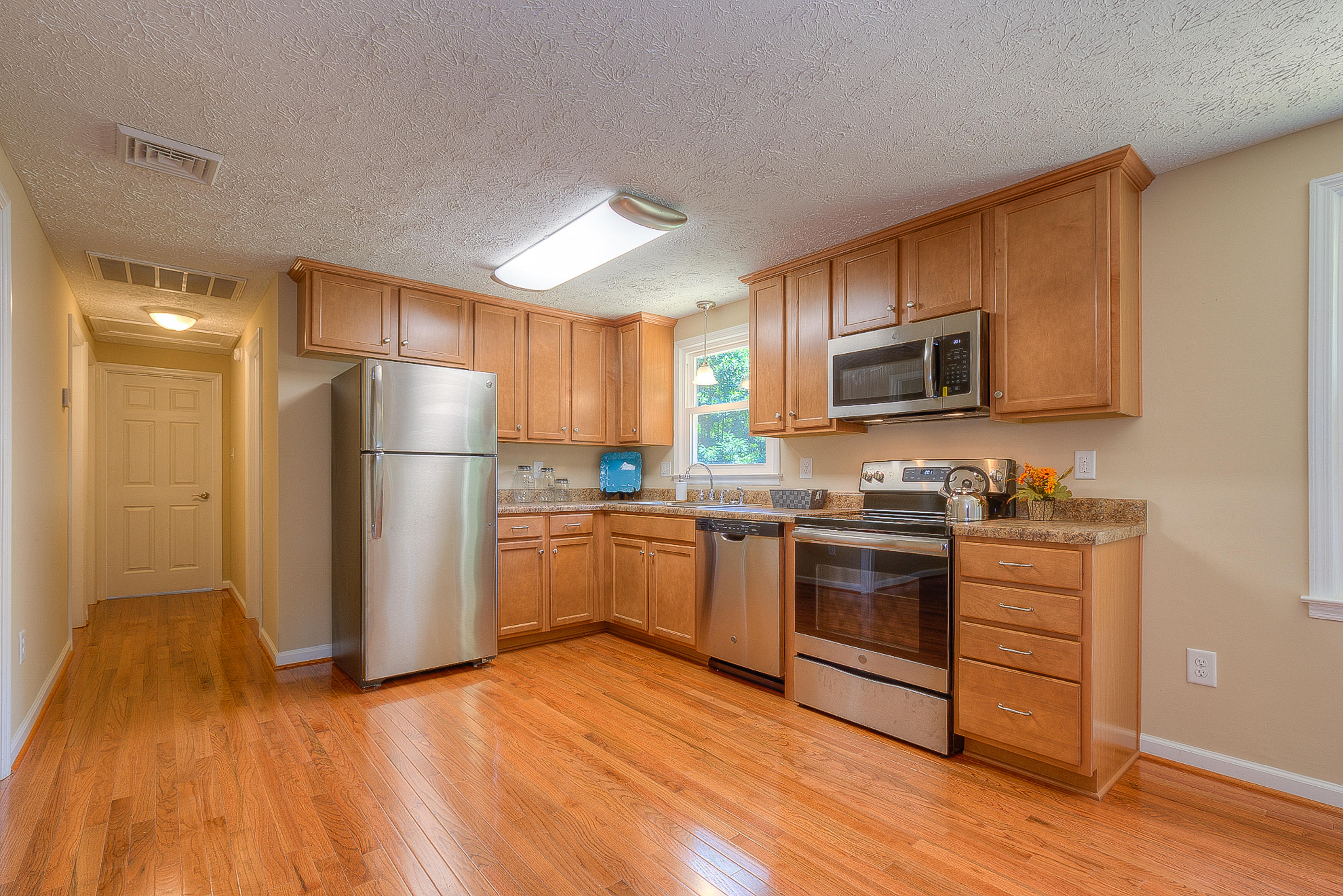2509 Rutrough Road Southeast Roanoke, VA 24014 - Photo 10 of 28 a kitchen with a refrigerator and a stove top oven