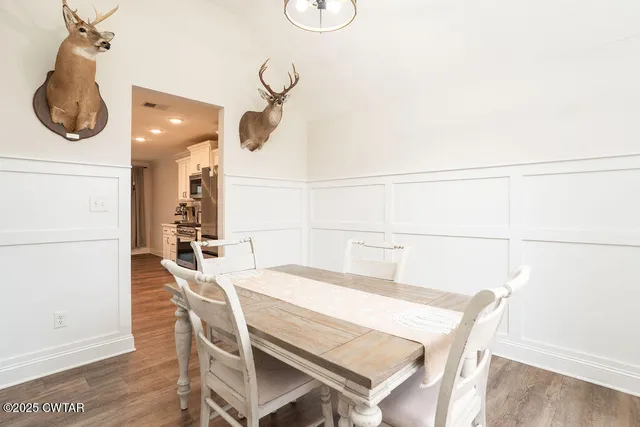 a dining room with a table and chairs