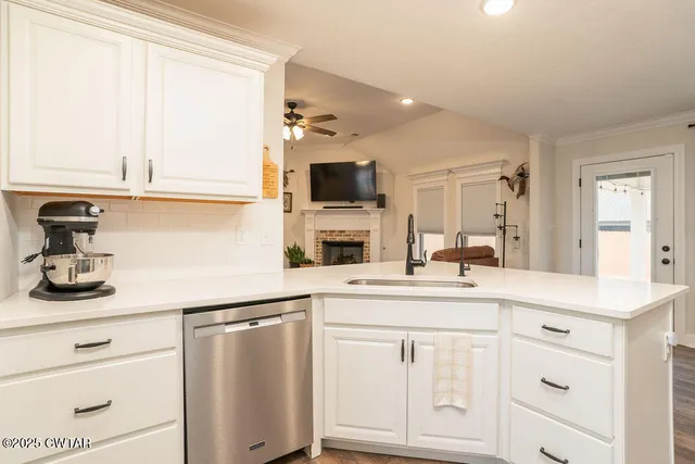a kitchen with white cabinets and appliances
