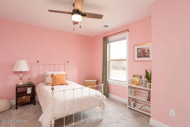 a bedroom with a bed and a lamp