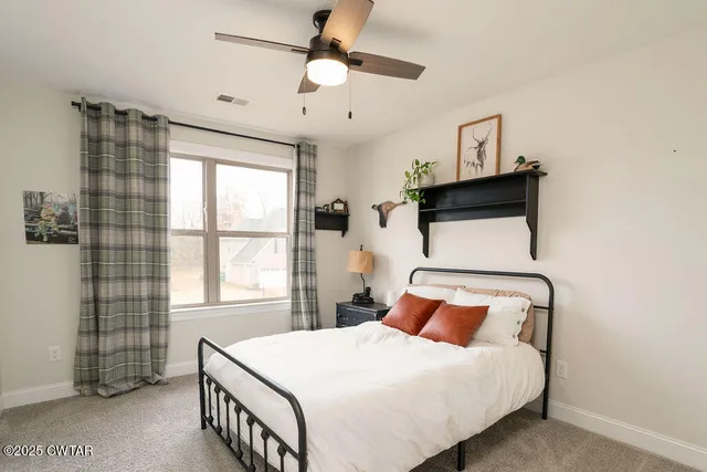 a bedroom with a bed and window