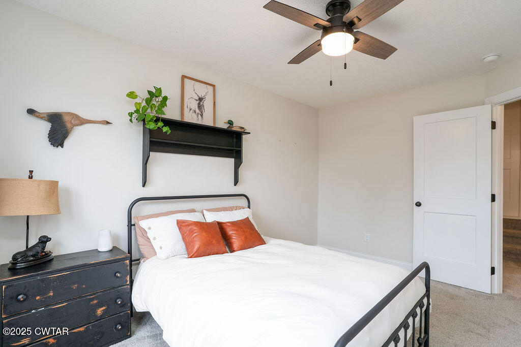 104 Springview Cove Medina, TN 38355 - Photo 25 of 37 a bedroom with a bed and a lamp on dresser