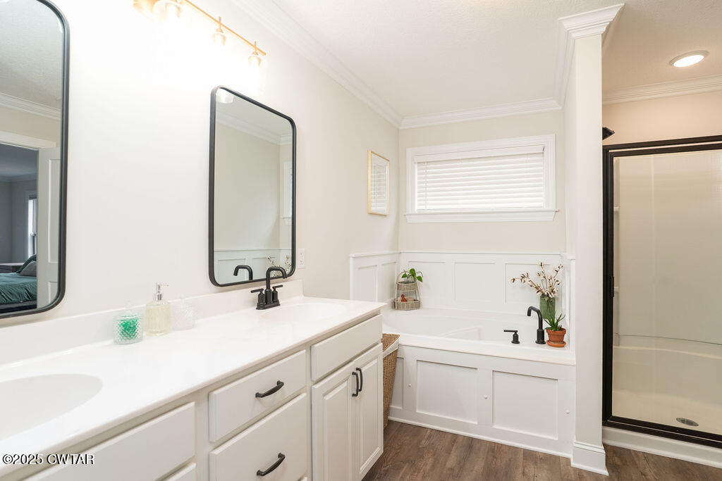 104 Springview Cove Medina, TN 38355 - Photo 33 of 37 a bathroom with a double vanity sink window and a bathtub