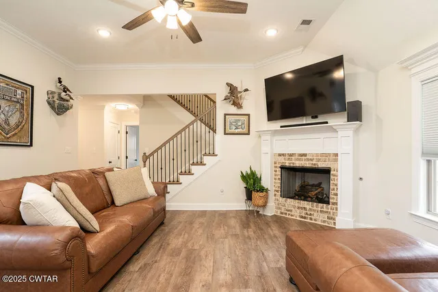 a living room with furniture fireplace and flat screen tv