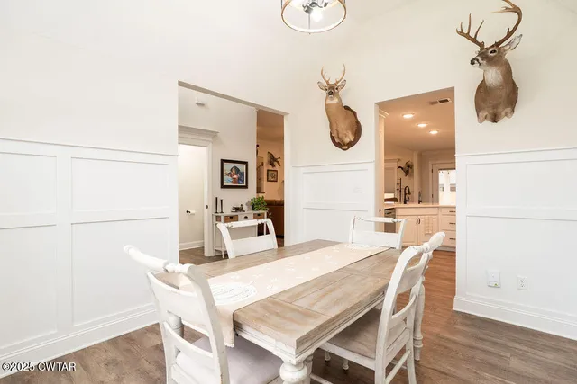 a dining room with furniture and a mirror