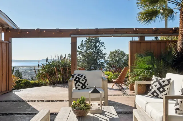 a view of a porch with furniture and a yard