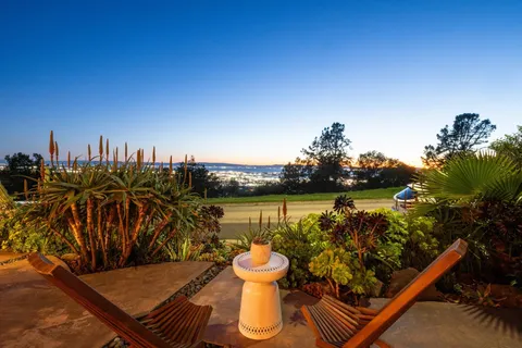 a view of chair and table in the garden