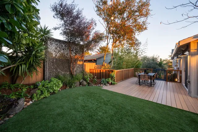 a view of a patio with table and chairs and wooden floor