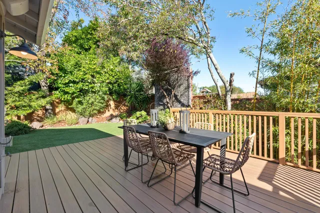 a kitchen with a table chairs microwave and cabinets