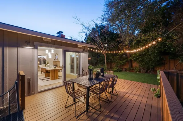 a kitchen with refrigerator a sink and chairs