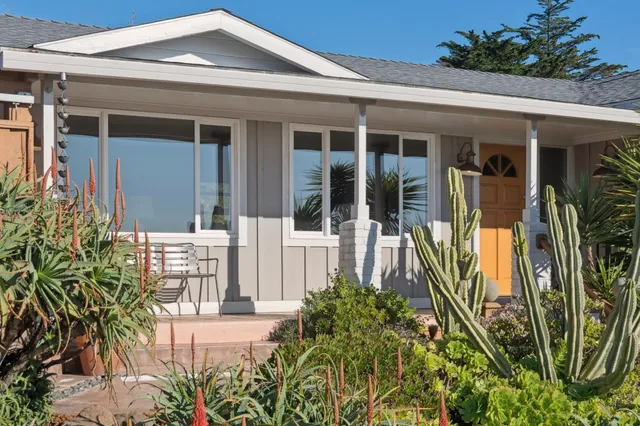 a front view of a house with garden