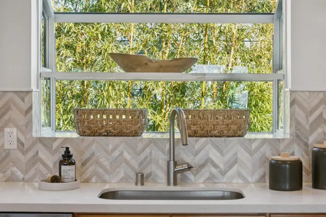 a bathroom with a sink and a large mirror