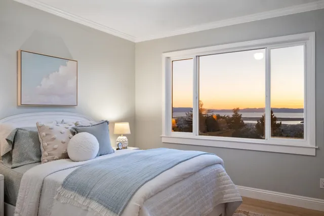 a bedroom with a bed and a painting on the wall