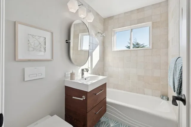 a living room with furniture a rug kitchen view and a chair