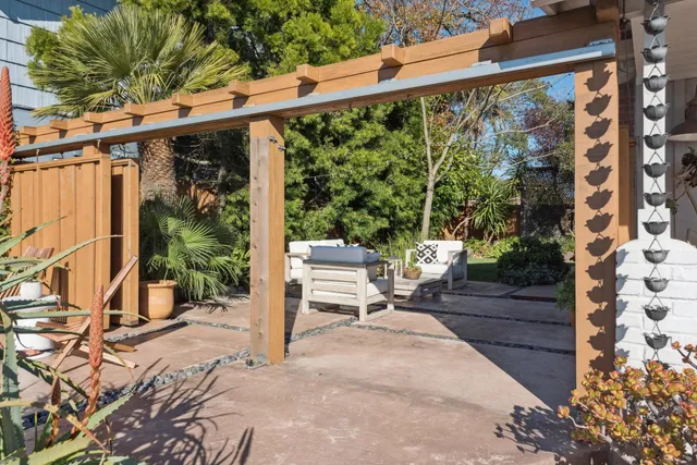 a picture of a bench in front of a gate