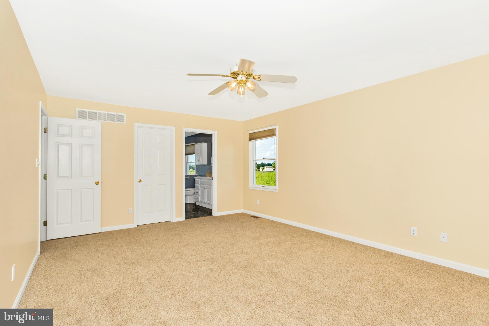 11841 Renner Road Keymar, MD 21757 - Photo 20 of 30 an empty room with windows and chandelier fan