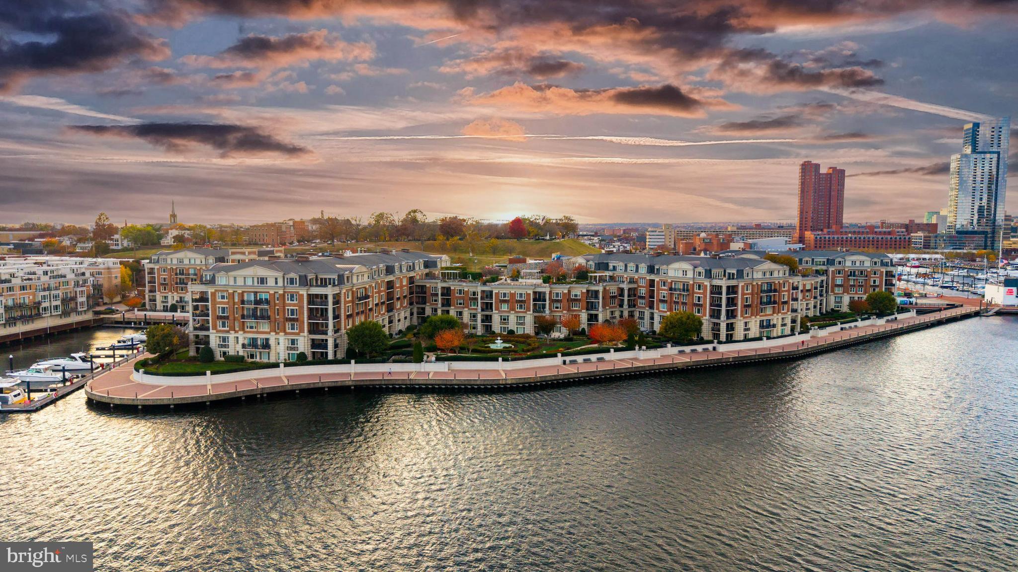 801 Key Highway, Unit 436 Baltimore, MD 21230 - Photo 6 of 27 a view of a lake with boats and trees in the background