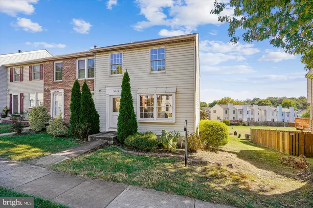 a view of a brick house with a yard