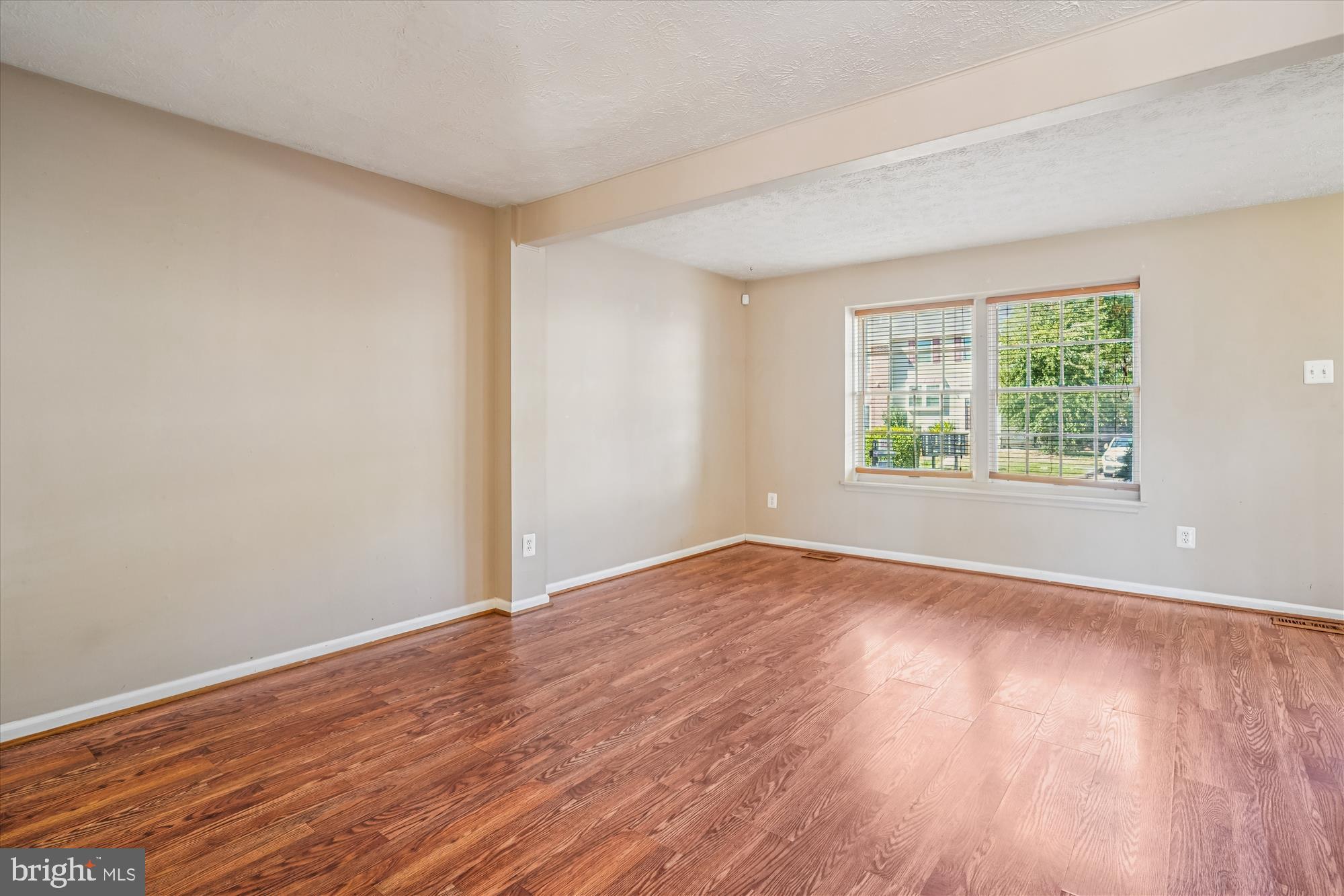 14740 Winding Loop Woodbridge, VA 22191 - Photo 12 of 59 a view of an empty room with wooden floor and a window