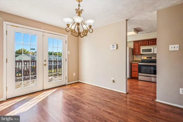 a kitchen with stainless steel appliances granite countertop a refrigerator sink and stove
