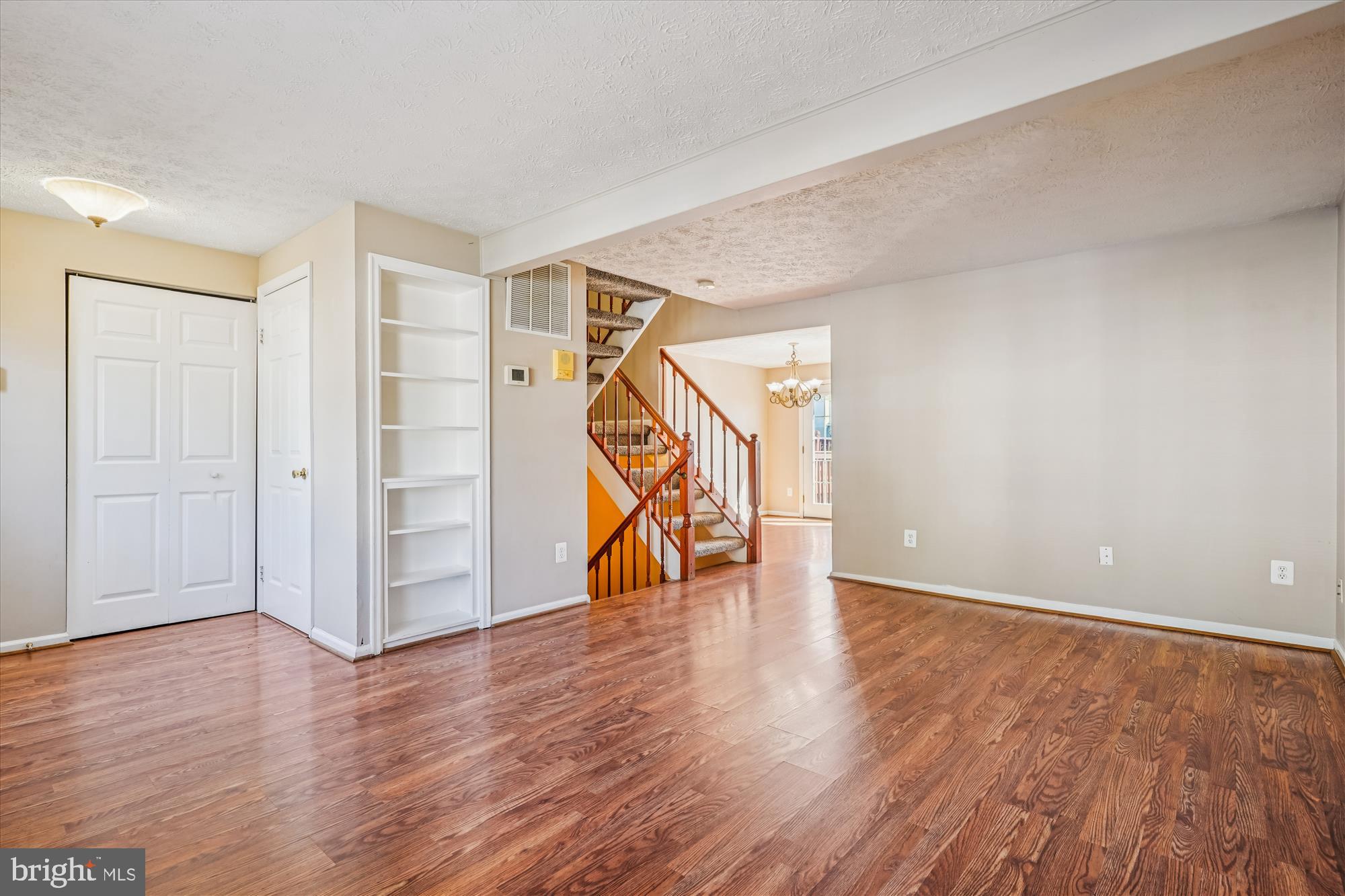 14740 Winding Loop Woodbridge, VA 22191 - Photo 19 of 59 a view of an empty room with wooden floor stairs and a window