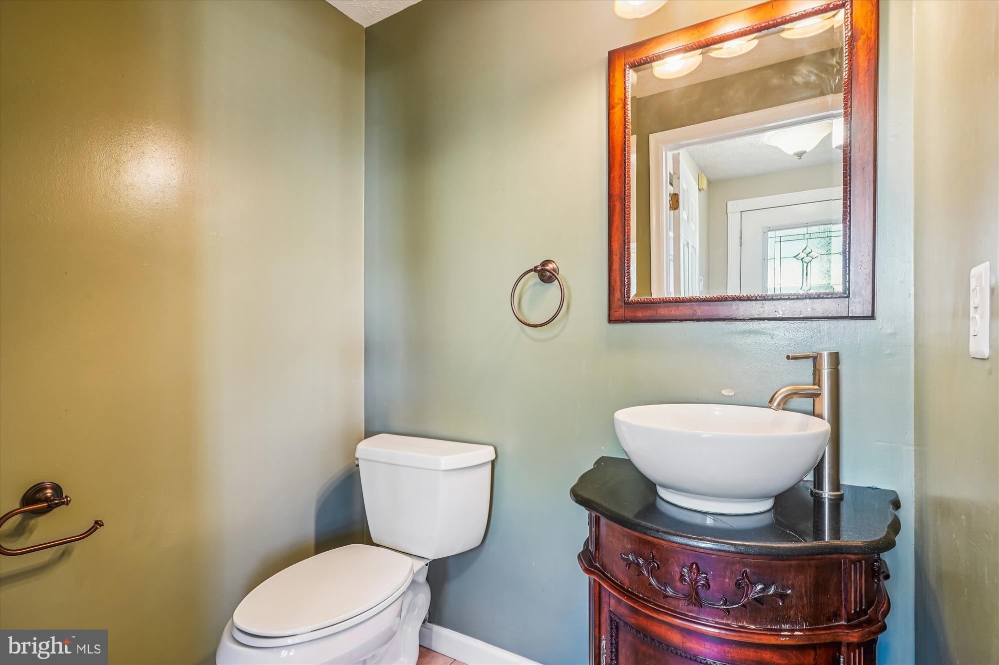 14740 Winding Loop Woodbridge, VA 22191 - Photo 20 of 59 a bathroom with a toilet a sink and mirror