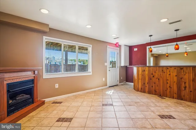 a view of an empty room with a fireplace