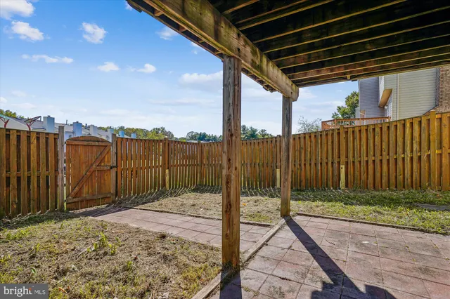 a view of a backyard with wooden fence