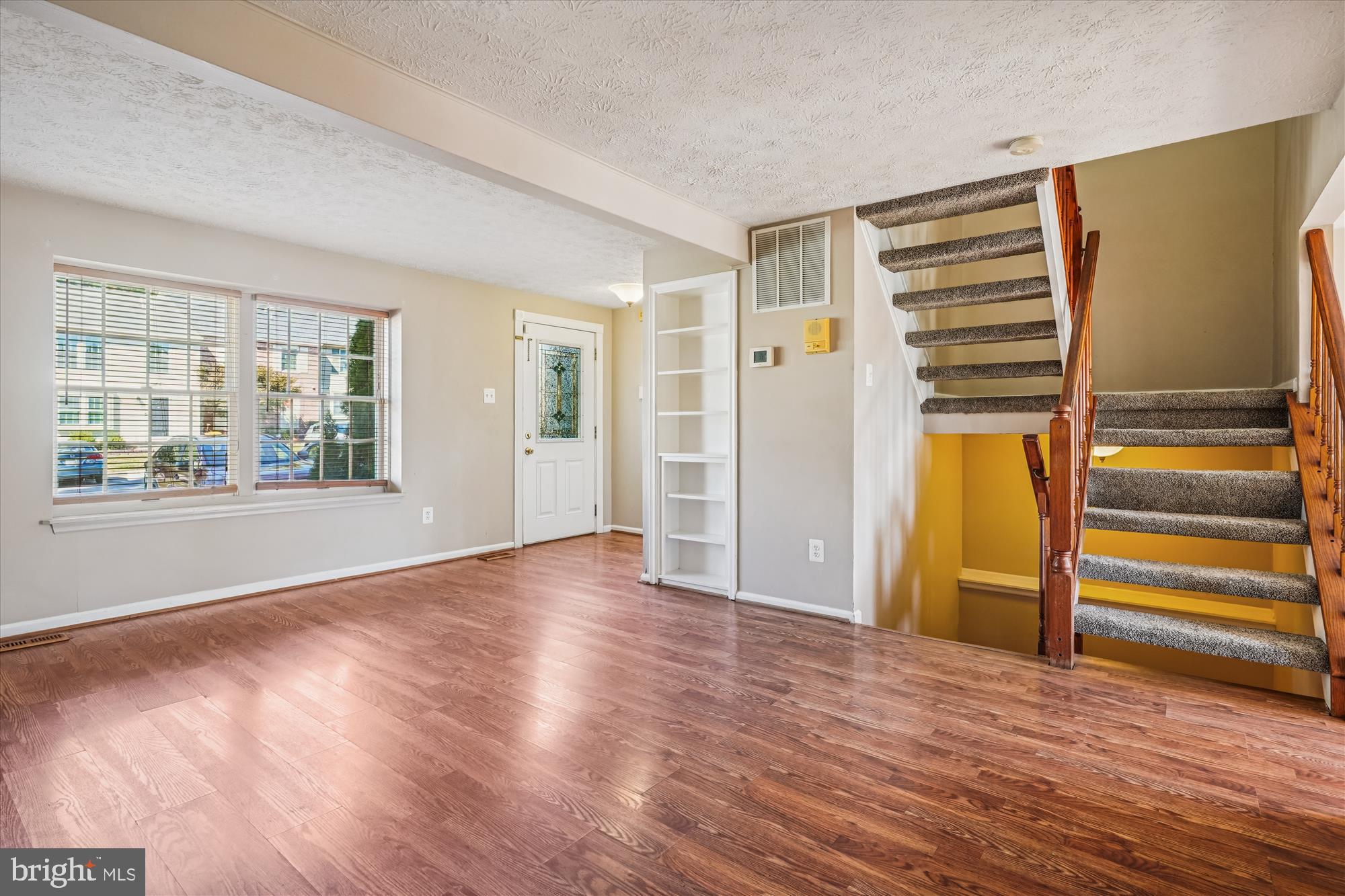 14740 Winding Loop Woodbridge, VA 22191 - Photo 8 of 59 an empty room with wooden floor closet and windows