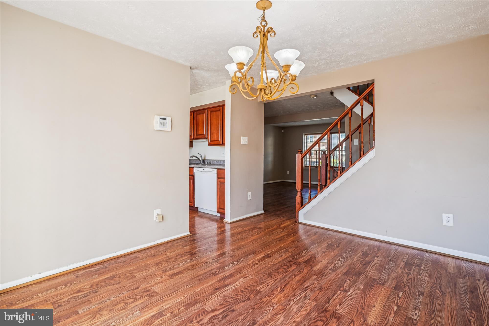 14740 Winding Loop Woodbridge, VA 22191 - Photo 9 of 59 a view of a hallway with wooden floor and a chandelier