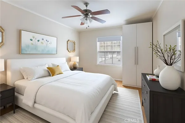 a bedroom with a large bed and a chandelier