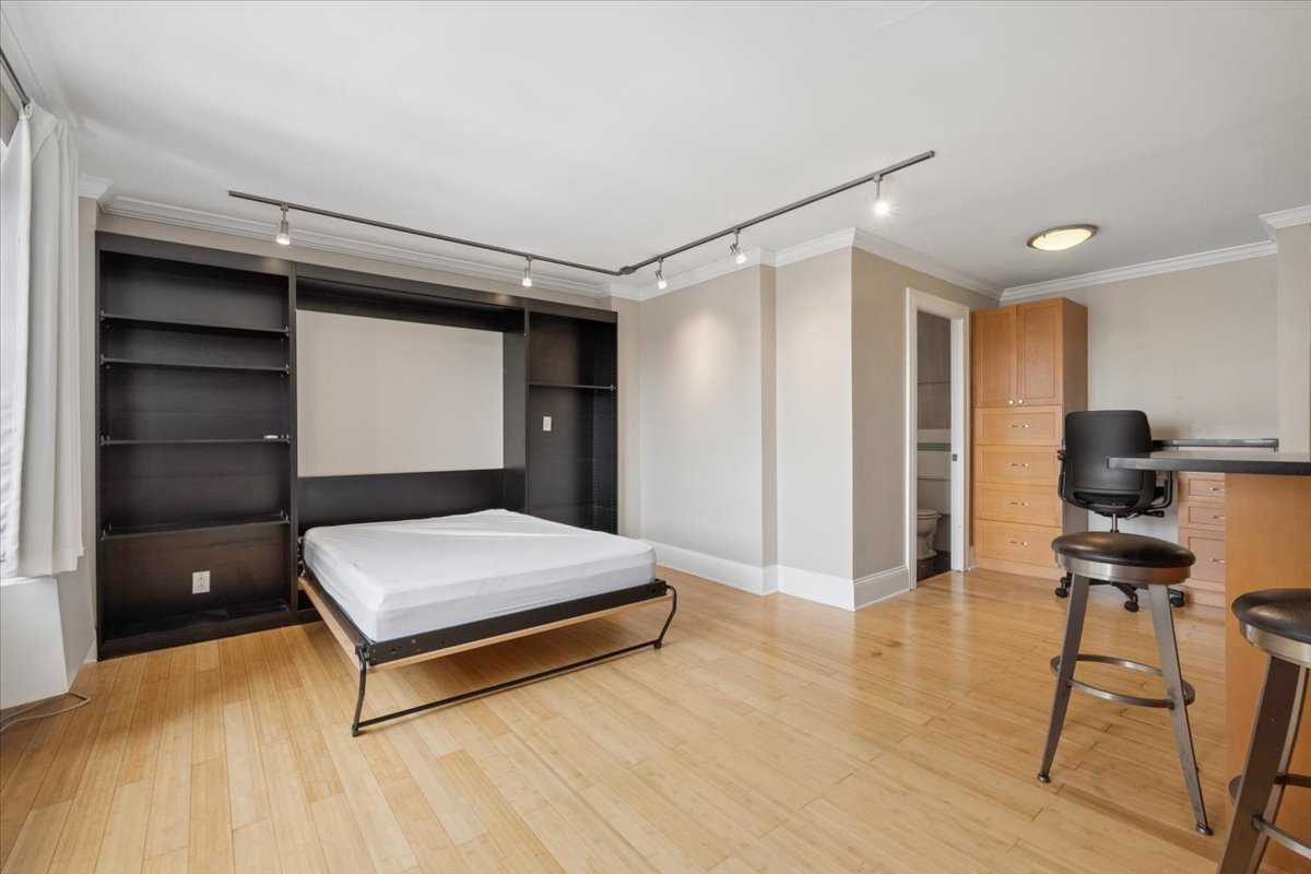 2909 North Sheridan Road, Unit 1201 Chicago, IL 60657 - Photo 4 of 16 a bedroom with a bed and a desk