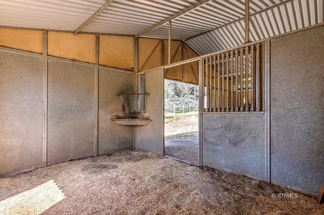 a bathroom with a granite countertop double vanity sink a mirror and a bathtub