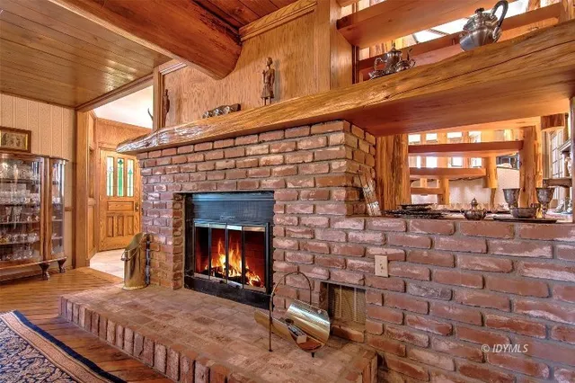 a view of a house with large windows and a tree