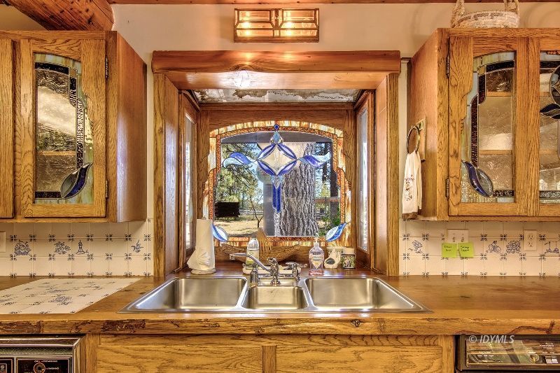35290 Butterfly Peak Road Mountain Center, CA 92561 - Photo 33 of 68 a view of a kitchen with granite countertop a sink and a window