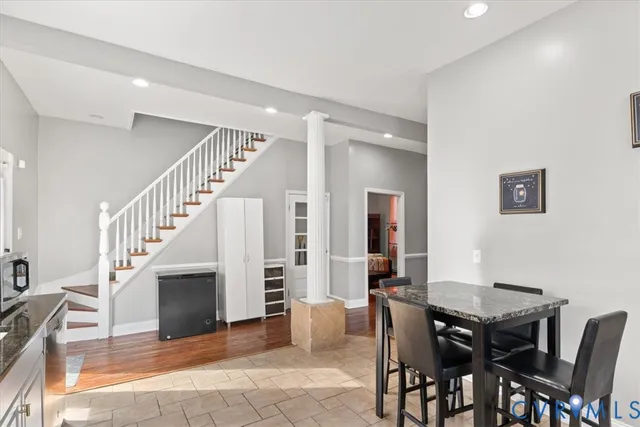 a view of a livingroom with furniture and staircase