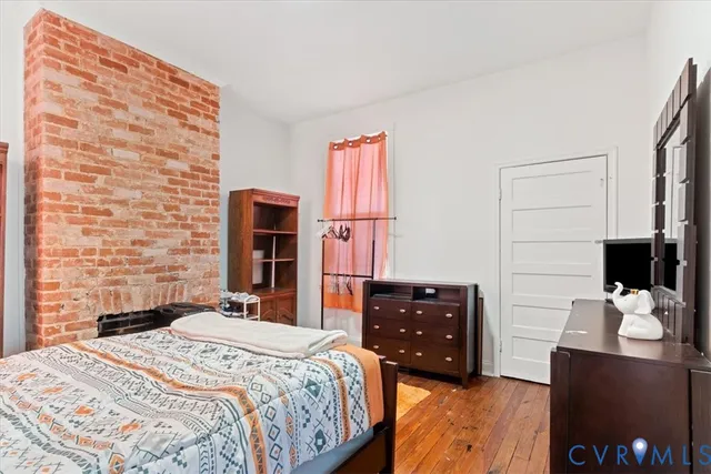 a bedroom with a bed and a television